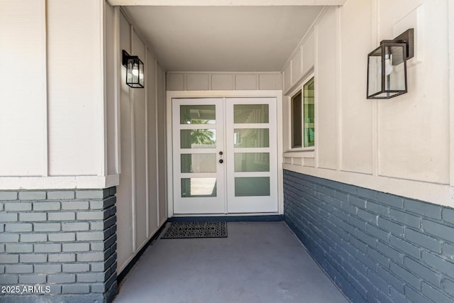13805 N 31st Ave, Phoenix, AZ 85053 - view of exterior entry featuring french doors and board and batten siding