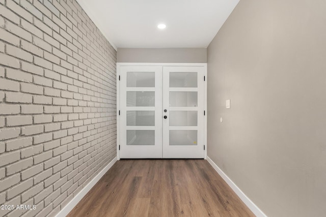 13805 N 31st Ave, Phoenix, AZ 85053 - entryway featuring french doors, brick wall, and dark wood-style flooring