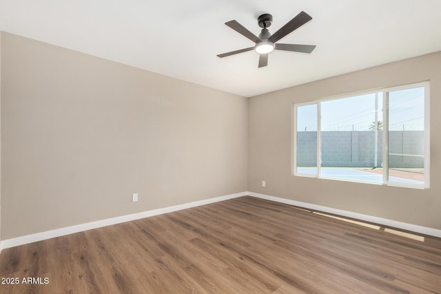 13805 N 31st Ave, Phoenix, AZ 85053 - empty room featuring wood finished floors and ceiling fan