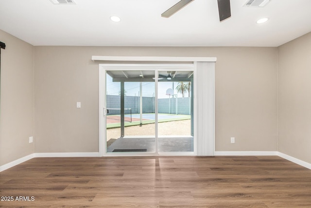13805 N 31st Ave, Phoenix, AZ 85053 - spare room with ceiling fan, wood finished floors, and recessed lighting