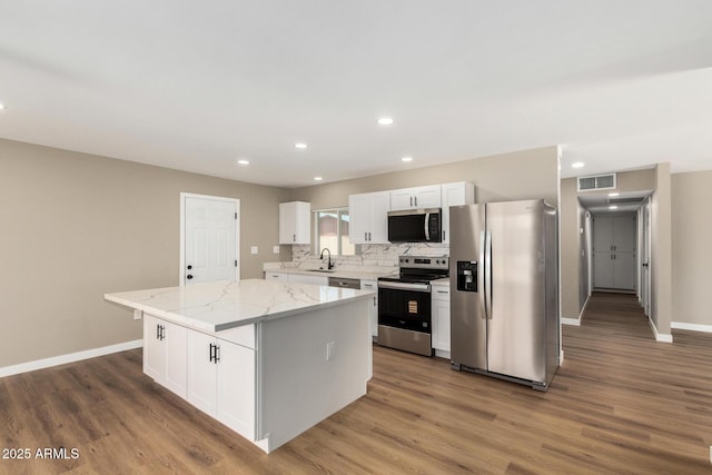 13805 N 31st Ave, Phoenix, AZ 85053 - kitchen featuring appliances with stainless steel finishes, white cabinetry, recessed lighting, and wood finished floors