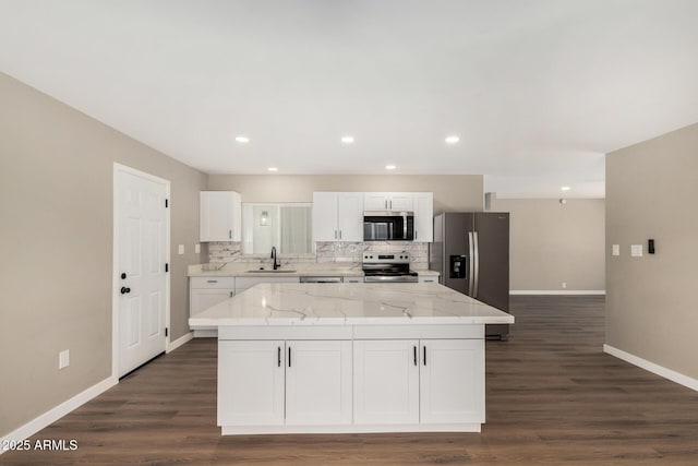 13805 N 31st Ave, Phoenix, AZ 85053 - kitchen featuring stainless steel appliances, white cabinetry, a center island, decorative backsplash, and dark wood finished floors