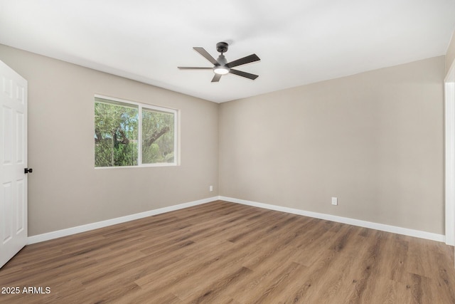 13805 N 31st Ave, Phoenix, AZ 85053 - empty room with a ceiling fan and light wood-style flooring