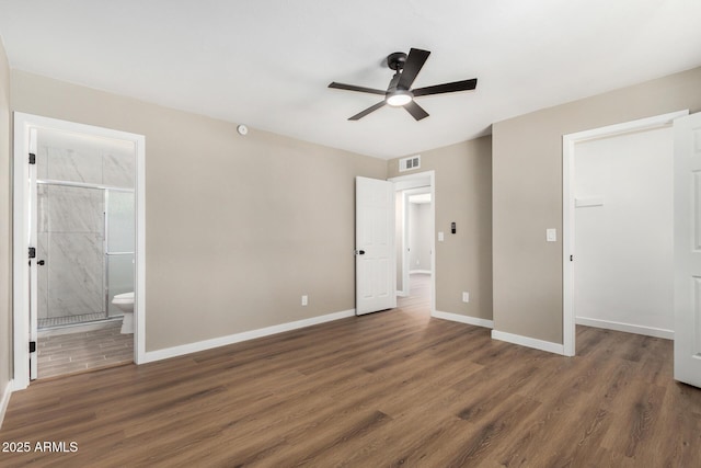 13805 N 31st Ave, Phoenix, AZ 85053 - unfurnished bedroom with a spacious closet, wood finished floors, a closet, connected bathroom, and ceiling fan