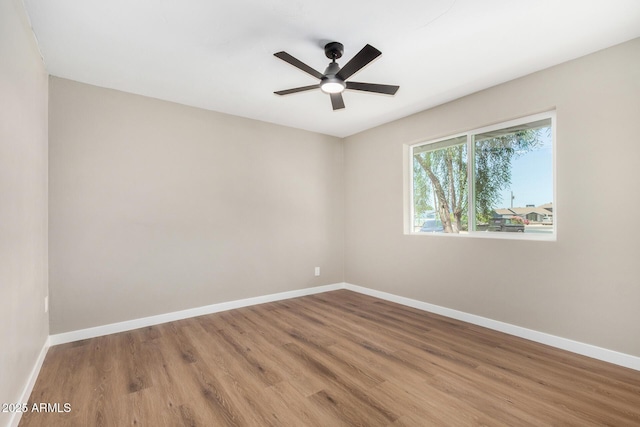 13805 N 31st Ave, Phoenix, AZ 85053 - unfurnished room featuring wood finished floors and a ceiling fan