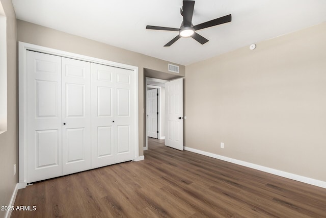 13805 N 31st Ave, Phoenix, AZ 85053 - unfurnished bedroom featuring wood finished floors, a closet, and a ceiling fan