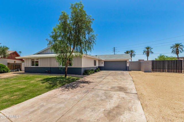 13805 N 31st Ave, Phoenix, AZ 85053 - ranch-style home featuring board and batten siding, a garage, driveway, brick siding, and a gate