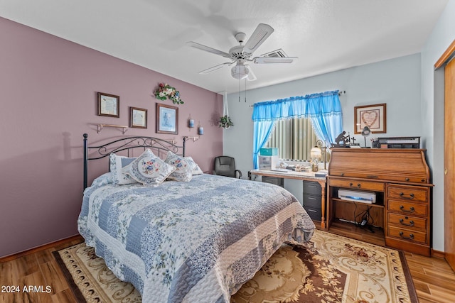 bedroom featuring a closet, light hardwood / wood-style floors, and ceiling fan