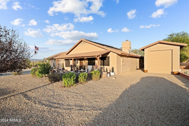 view of front of house featuring an outdoor structure and a garage