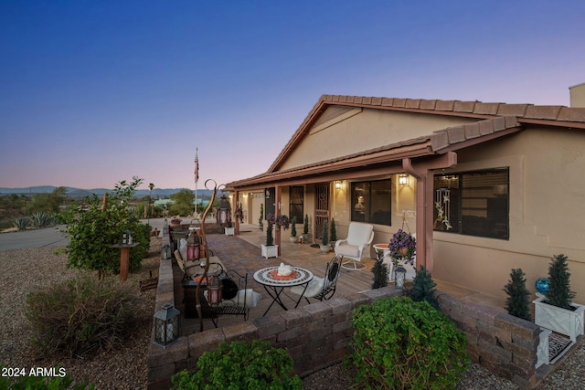 patio terrace at dusk with an outdoor fire pit