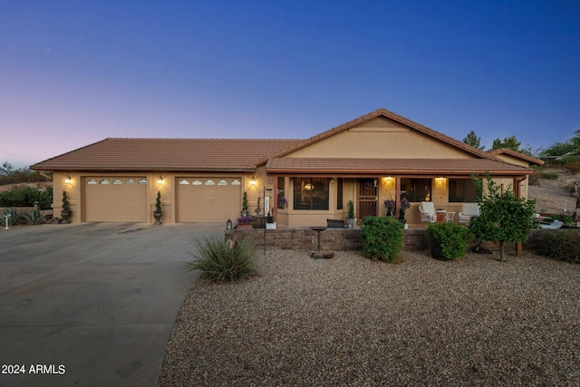 view of front of house featuring a garage and covered porch