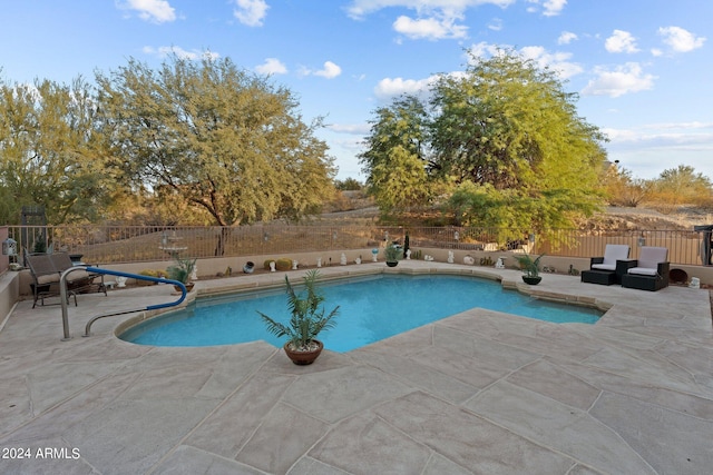 view of swimming pool with a patio