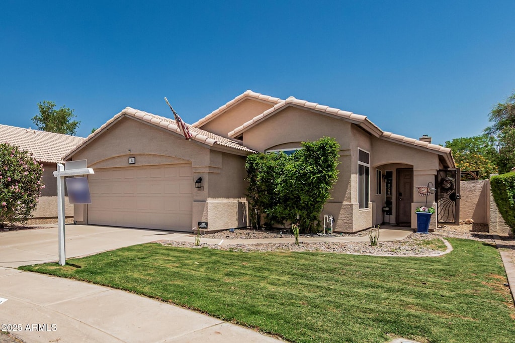 51 N Rush St, Chandler, AZ 85226 - view of front of house featuring a garage, stucco siding, concrete driveway, a front lawn, and a tiled roof