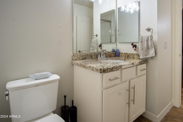 bathroom featuring tile patterned flooring, vanity, and toilet