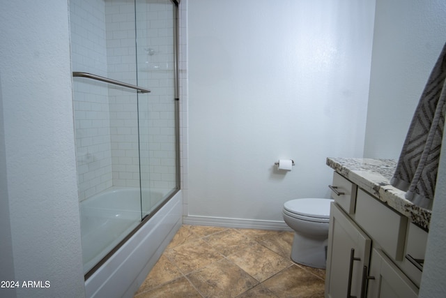 full bathroom with vanity, toilet, and combined bath / shower with glass door