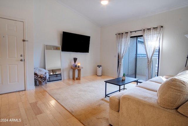 living room featuring ornamental molding, wood-type flooring, and lofted ceiling