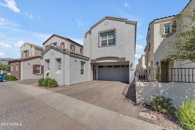 mediterranean / spanish home with a garage