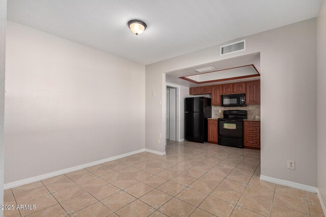 kitchen with decorative backsplash, light tile patterned flooring, and black appliances