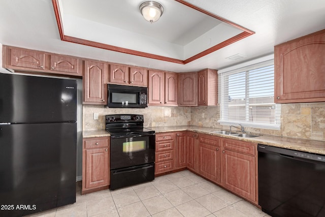 kitchen featuring black appliances, a raised ceiling, light tile patterned floors, and sink