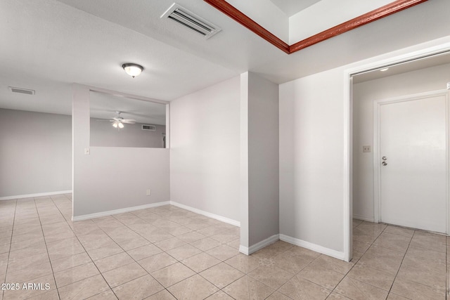 tiled empty room featuring ceiling fan