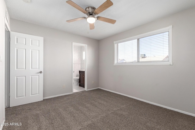 unfurnished bedroom featuring carpet flooring, ensuite bathroom, and ceiling fan