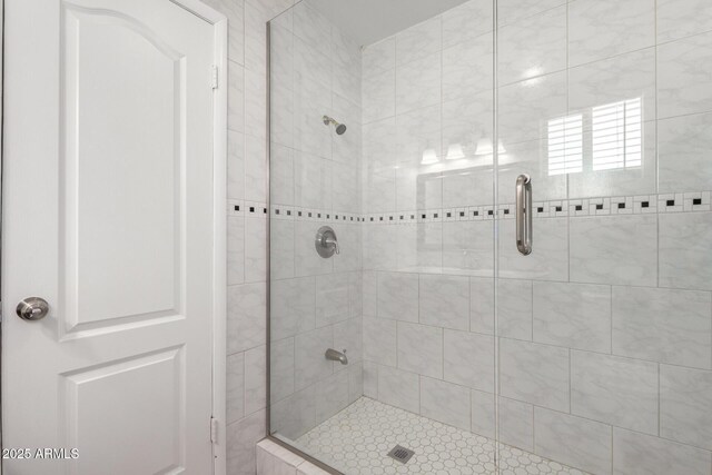 bathroom with a shower with door