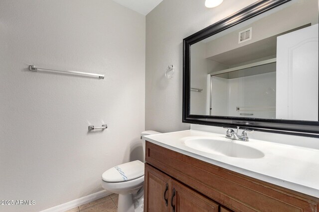 bathroom featuring tile patterned floors, a shower, vanity, and toilet