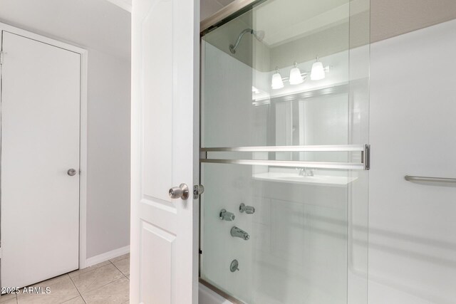 bathroom with tile patterned floors and combined bath / shower with glass door