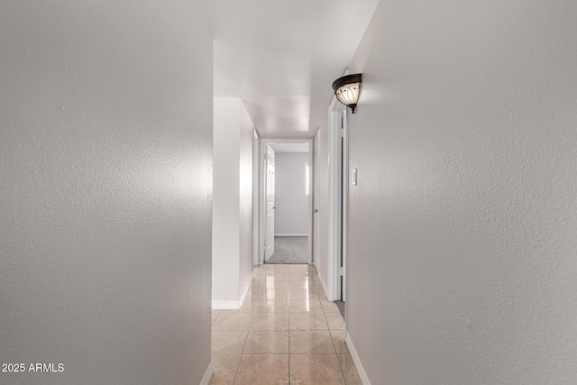 hallway featuring light tile patterned floors