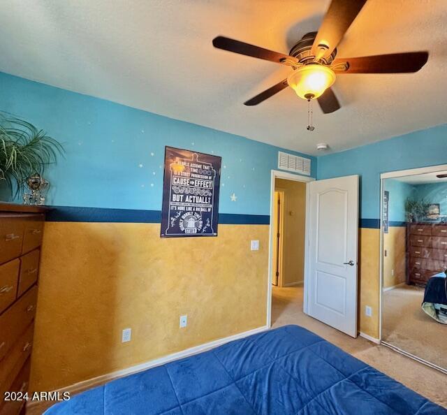 bedroom featuring ceiling fan and a closet