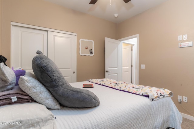 carpeted bedroom with a ceiling fan, a closet, and baseboards