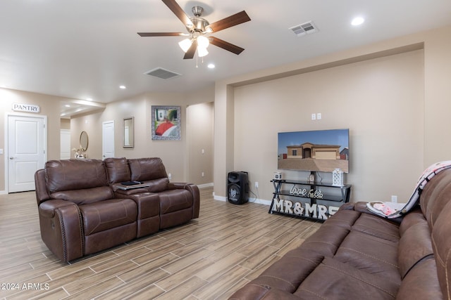 living area featuring wood finish floors, visible vents, and a ceiling fan