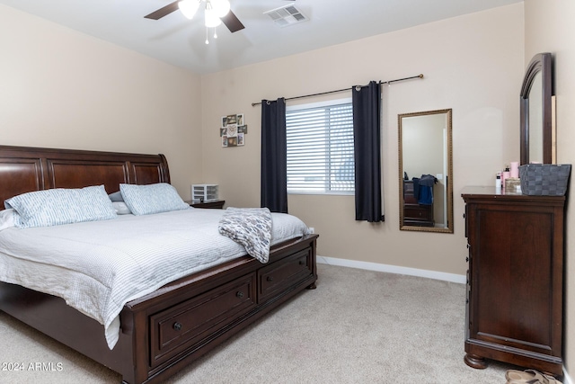 bedroom featuring a ceiling fan, visible vents, light carpet, and baseboards