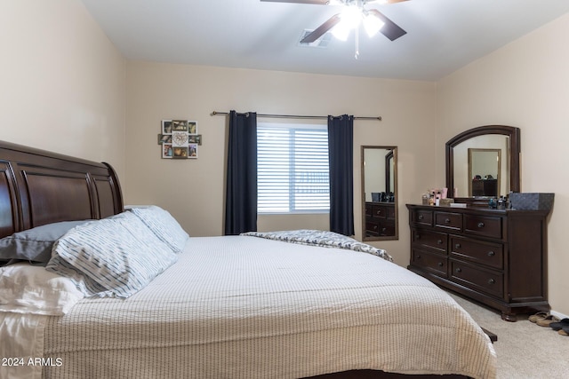 bedroom featuring a ceiling fan and light colored carpet