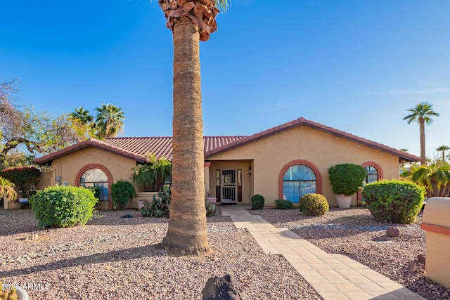 mediterranean / spanish-style home featuring stucco siding and a tiled roof
