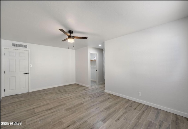 7101 N 36th Ave Unit 102, Phoenix, AZ 85051 - spare room featuring a ceiling fan, light wood-style floors, and baseboards