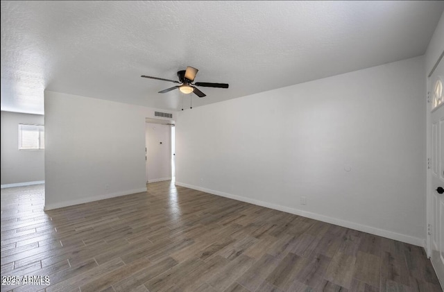 7101 N 36th Ave Unit 102, Phoenix, AZ 85051 - empty room with a ceiling fan, wood finished floors, baseboards, and a textured ceiling