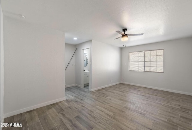 7101 N 36th Ave Unit 102, Phoenix, AZ 85051 - spare room featuring a ceiling fan, wood finished floors, baseboards, and recessed lighting