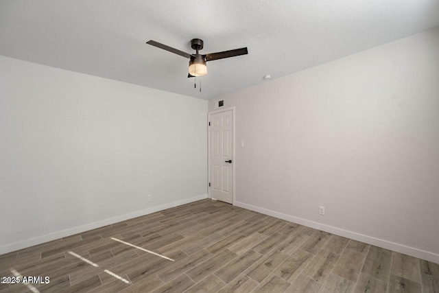 7101 N 36th Ave Unit 102, Phoenix, AZ 85051 - spare room with wood finished floors, a ceiling fan, and baseboards
