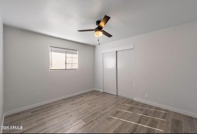 7101 N 36th Ave Unit 102, Phoenix, AZ 85051 - unfurnished bedroom with wood finished floors, a closet, a ceiling fan, and baseboards