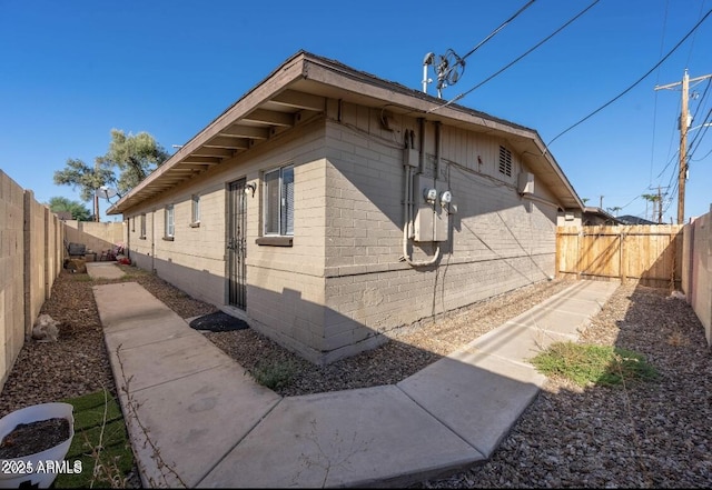 7101 N 36th Ave Unit 102, Phoenix, AZ 85051 - view of home's exterior with a fenced backyard and brick siding