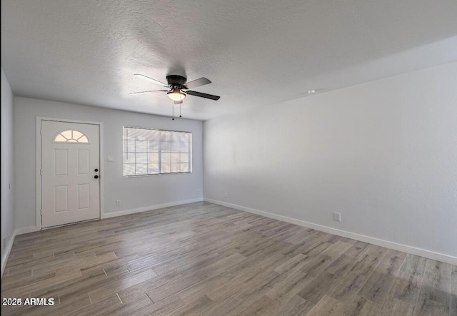 7101 N 36th Ave Unit 102, Phoenix, AZ 85051 - foyer entrance with a ceiling fan, wood finished floors, baseboards, and a textured ceiling