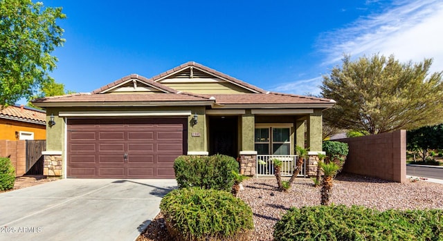 2597 E Hickory St, Gilbert, AZ 85298 - single story home with concrete driveway, a porch, an attached garage, stone siding, and stucco siding