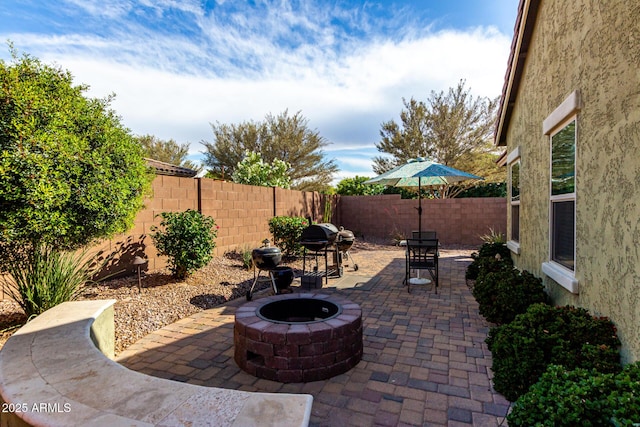 2597 E Hickory St, Gilbert, AZ 85298 - fenced backyard featuring a fire pit, a patio area, and area for grilling