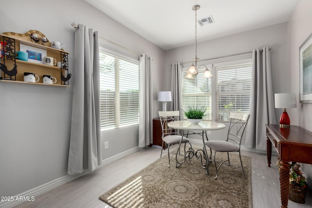 2597 E Hickory St, Gilbert, AZ 85298 - dining space with baseboards, wood finished floors, and a chandelier