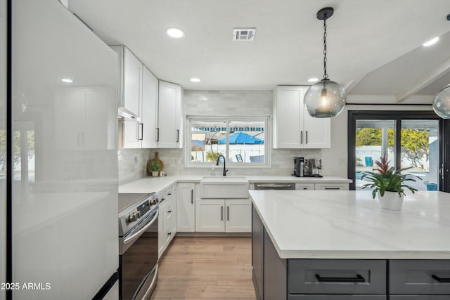 kitchen featuring light stone countertops, appliances with stainless steel finishes, white cabinetry, sink, and gray cabinets