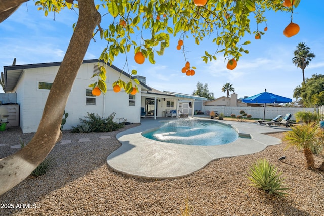 view of swimming pool featuring pool water feature and a patio