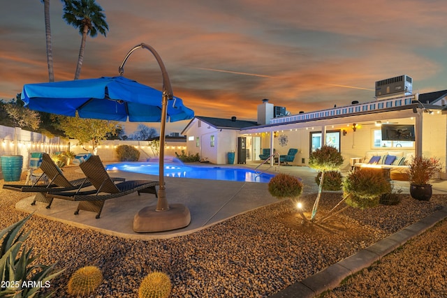 pool at dusk featuring a patio area, an outdoor hangout area, and central air condition unit