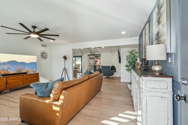 living room featuring ceiling fan and light hardwood / wood-style flooring