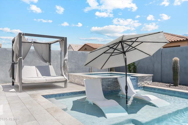 view of swimming pool with a pool with connected hot tub and fence